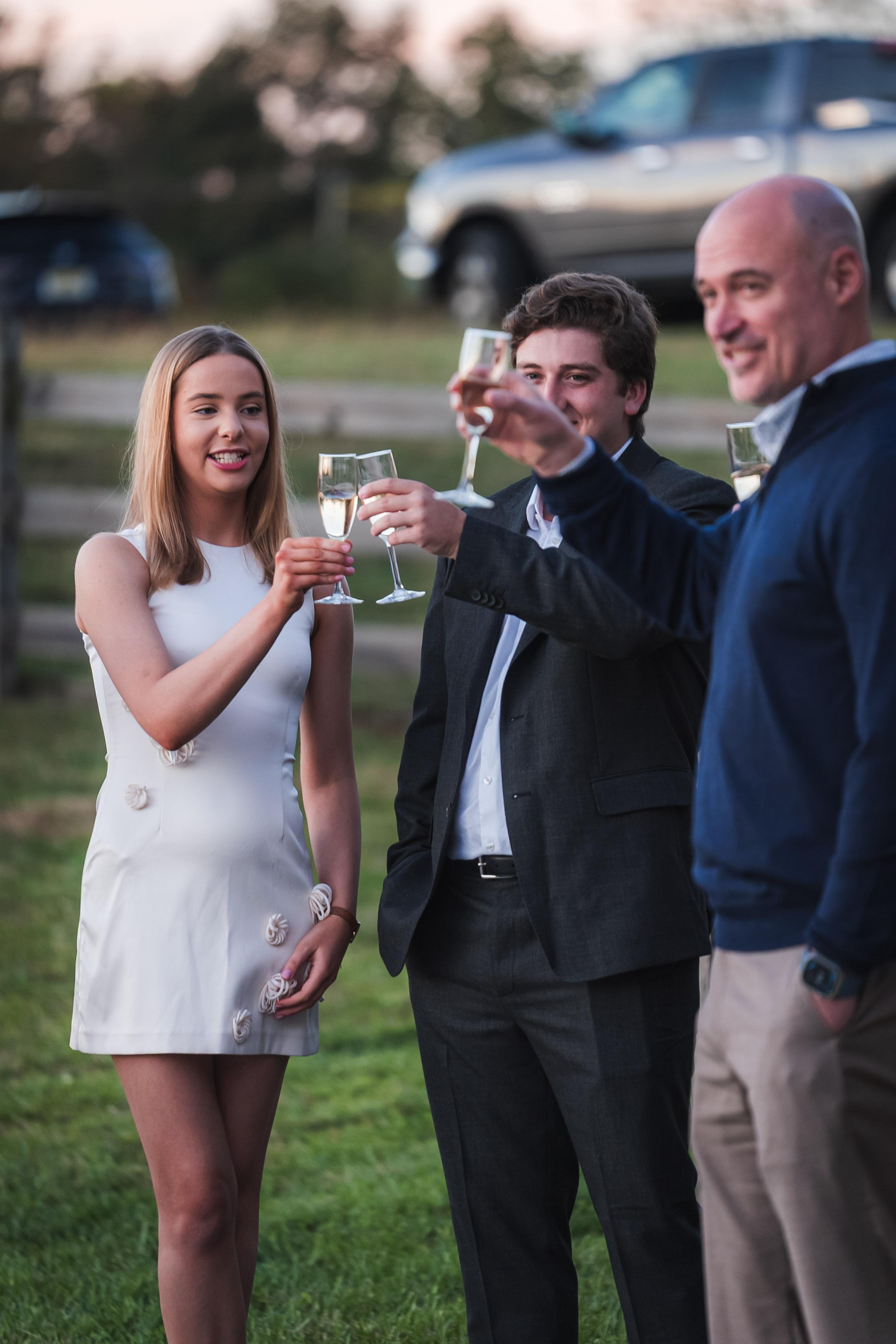 Guests raising glasses during a Dragonfly Catering celebration in Chester County